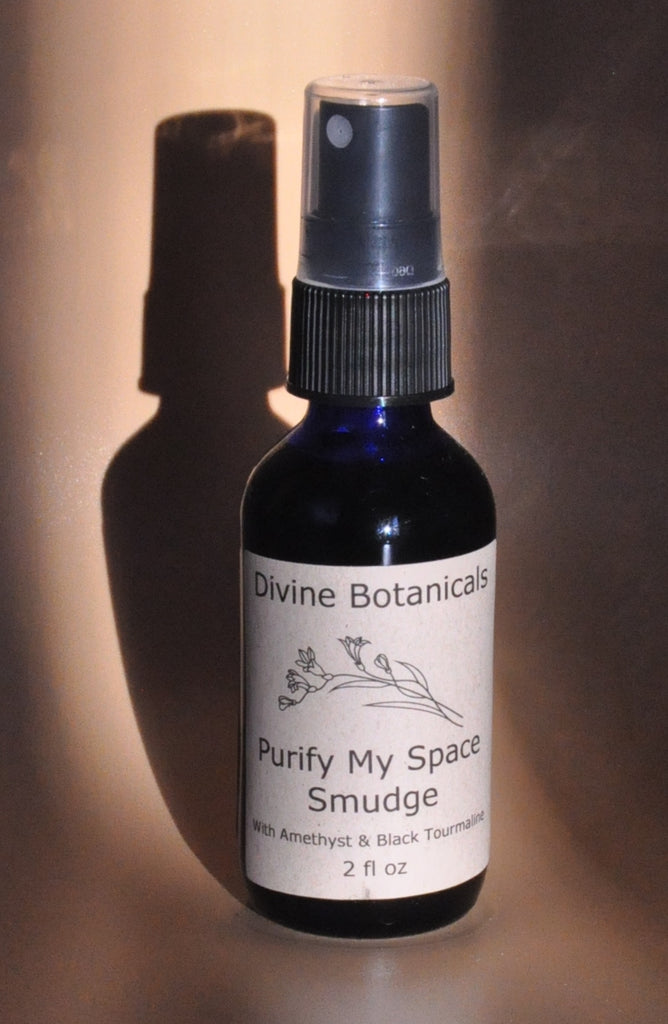 A cobalt blue pump-spray bottle of Purify My Space Smudge